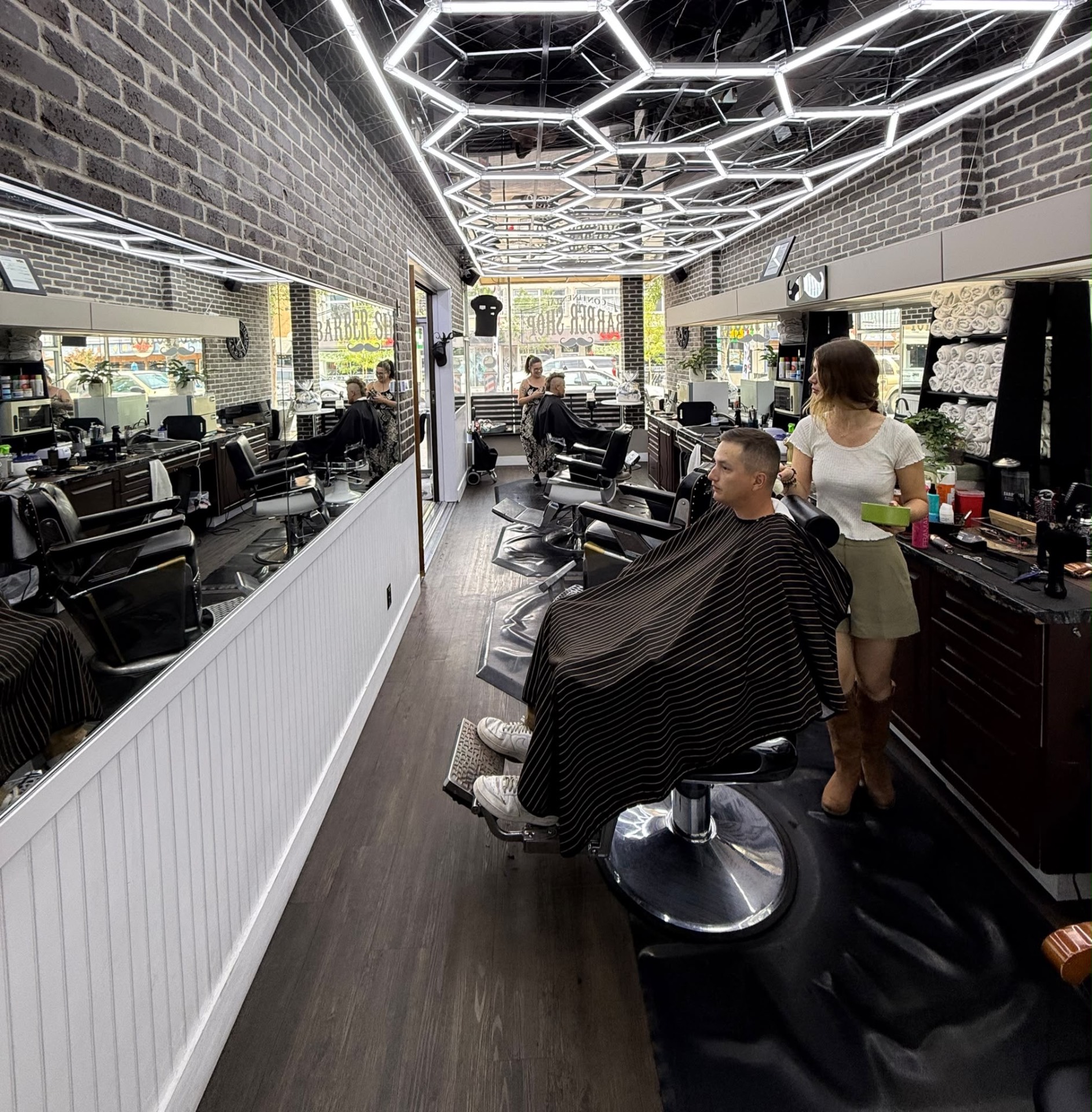 Inside Continental Barbershop Kamloops — honeycomb LED interior