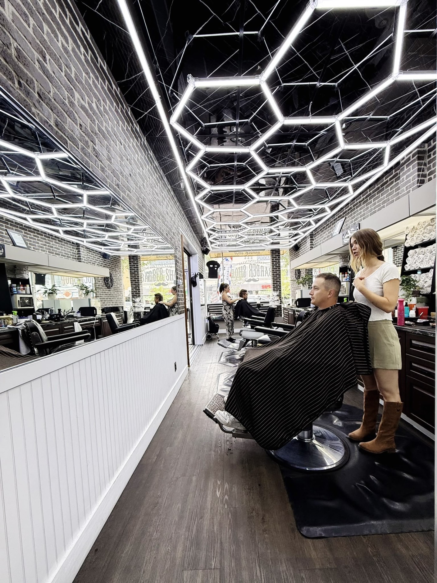 Continental Barbershop Kamloops interior with hexagon LED lights on Victoria Street