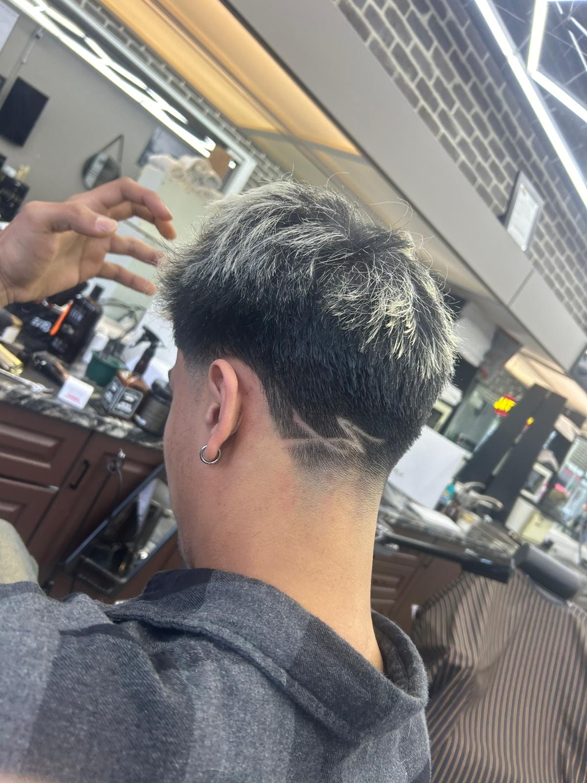 Textured crop with hair design and low fade by Ariel at Continental Barbershop Kamloops