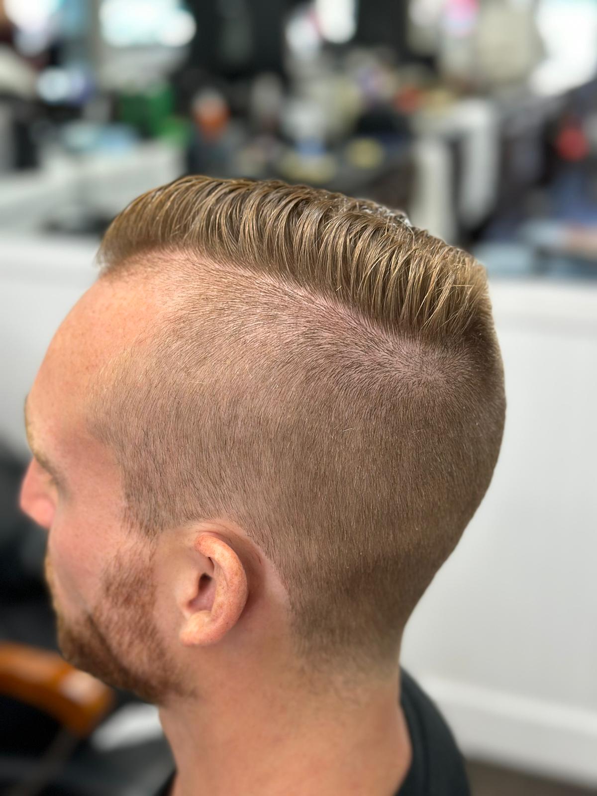 Clean side part with skin fade at Continental Barbershop Kamloops