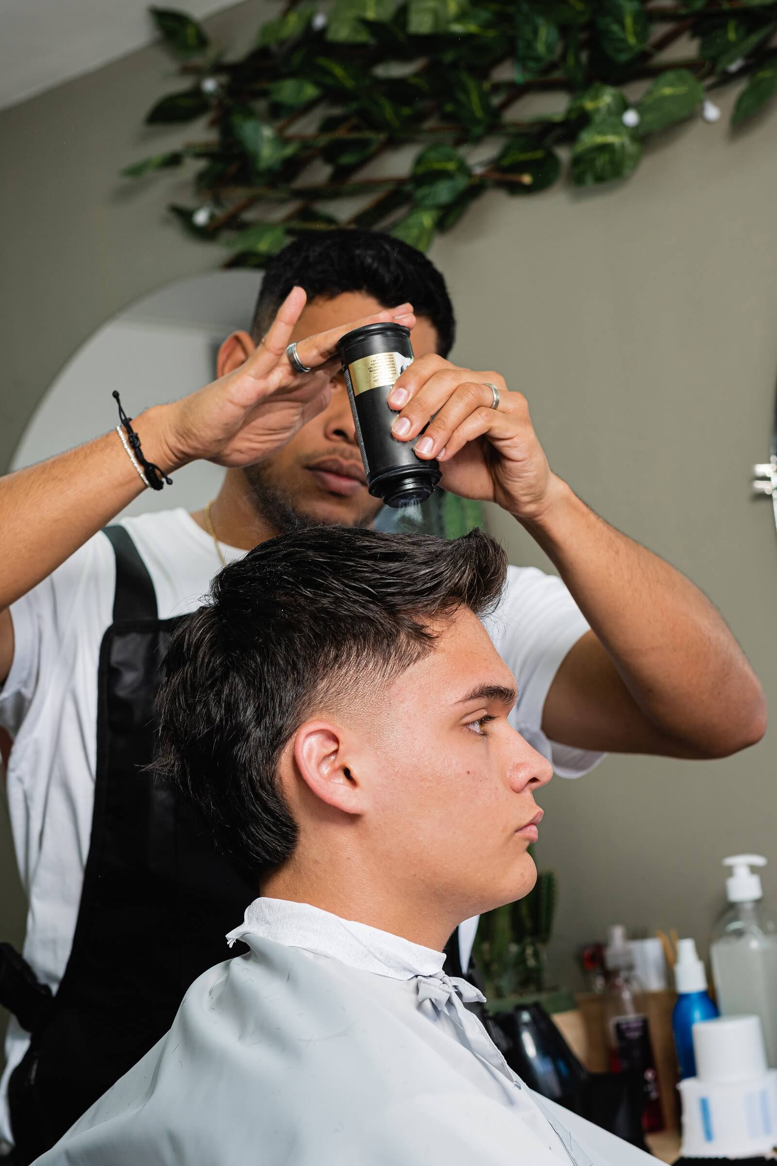 client-receiving-a-haircut-service-in-a-barbershop-ZPLAGXQ.jpg